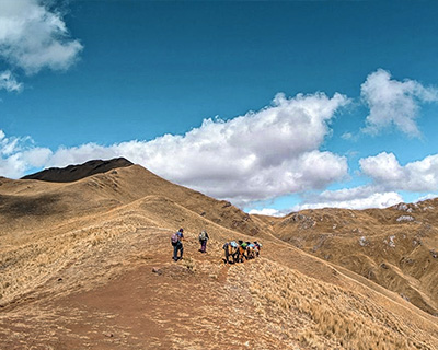 Man next to Apacheta on top of the mountains