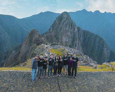 Group of trekkers and their guide at on the Machu Picchu viewpoint