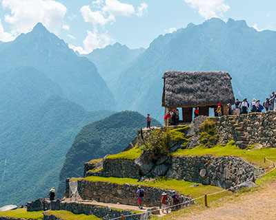 Man with arms up enjoying MachuPicchu