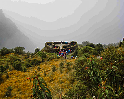 Woman enjoying the landscape above the mountains on Inca trail - Warmiwañusca