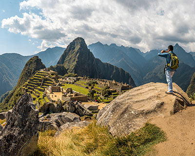 Man taking photos of MachuPicchu on a sunny day