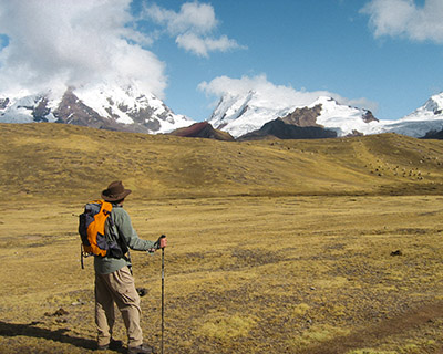 Man resting and a background image of the snow-capped Ausangate