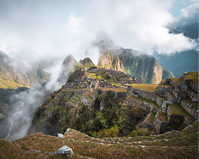 Magical image of Machu Picchu in the middle of the clouds and at the entrance of the sun