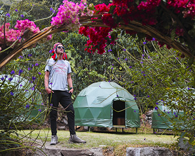 Man in the middle of the jungle domes, flowers and trees