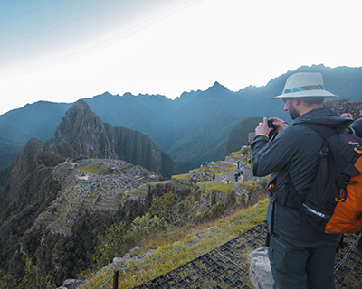 Man is taking a photo of MachuPicchu of a viewpoint